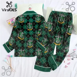 Slytherin House pajama set with green and black argyle pattern and white piping on a white bed sheet background.!