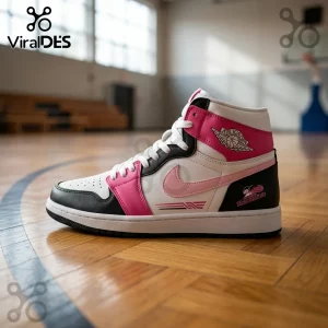 High-top sneaker in white, black, and pink leather with Air Jordan wing logo and Thunderbirds emblem on a gym floor.!
