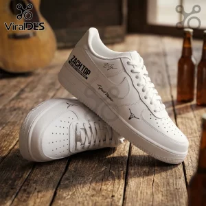 Custom white leather sneakers with Zach Top branding, longhorn skull graphics, and personalized name text on wooden floor.!