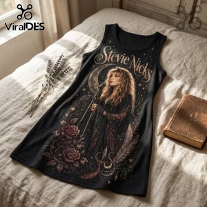 Black tank dress featuring a Stevie Nicks graphic, crescent moon, roses, feathers, and text on a beige bedspread.!
