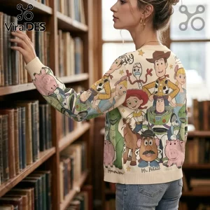 Cream knit sweater featuring an all-over Toy Story character print including Woody, Buzz Lightyear, and Mr. Potato Head.!