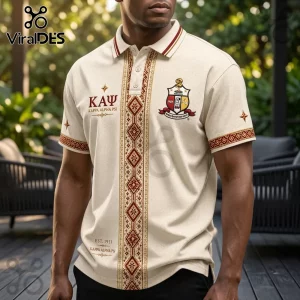Cream-colored Kappa Alpha Psi polo shirt with vertical red and gold geometric patterns and fraternity crest embroidery.!