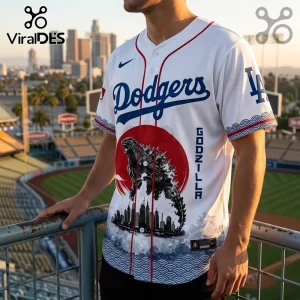 Godzilla Minus One x Los Angeles Dodgers 2026 baseball jersey featuring a red sun graphic, monster silhouette, and cityscape.