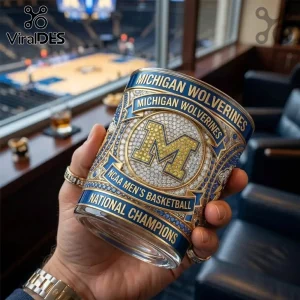 Michigan Wolverines NCAA basketball championship glass tumbler with blue, yellow, and diamond-studded M logo and text.!
