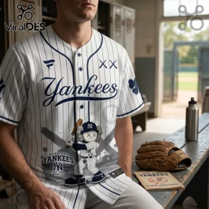 White New York Yankees pinstripe baseball jersey with blue KAWS-style character graphic holding a wooden bat.!