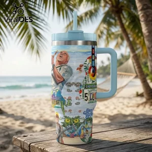 Jimmy Buffett Margaritaville 40oz travel handle tumbler with tropical parrot and beach graphics on a wooden table.