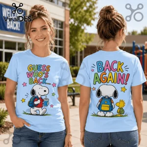 Light blue t-shirt displaying Snoopy with a backpack on the front and back, featuring colorful school-themed text graphics.!