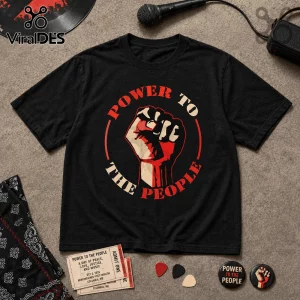 Black cotton t-shirt featuring a red and cream circular fist graphic with Power To The People text on a gray surface.!