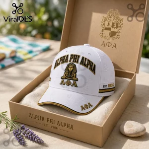Alpha Phi Alpha Sphinx Premium White Baseball Cap with black and gold embroidered lettering and symbols in a gift box.