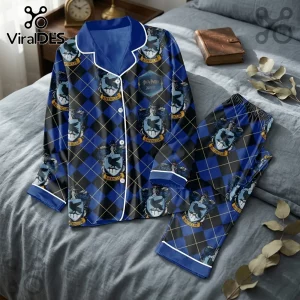 Ravenclaw pajama set in blue and black argyle pattern featuring Harry Potter house crests on a gray bedspread.!