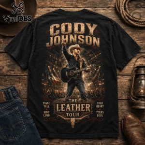 Black cotton t-shirt featuring Cody Johnson performing on stage with a guitar, Texas flag, and The Leather Tour text.!
