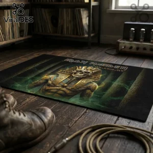 Iron Maiden Powerslave Egyptian Mummy area rug featuring Eddie the Head in gold and black on a dark wooden floor.