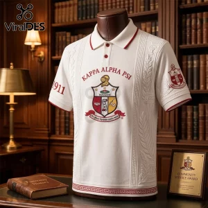 Kappa Alpha Psi polo shirt in white featuring red embroidery, 1911 text, and Greek crest on a mannequin in a library.!