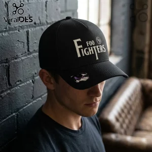 Black structured baseball cap featuring white Foo Fighters logo text and a circular emblem against a dark brick wall.!