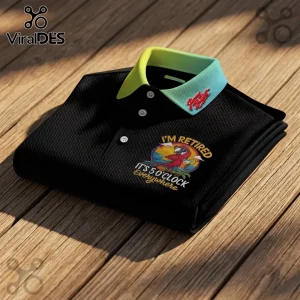 Jimmy Buffett It's 5 O'Clock Everywhere polo shirt in black with a contrasting neon green collar on wooden planks.