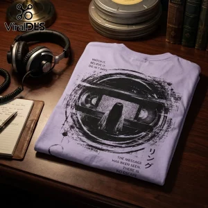 Light purple t-shirt featuring The Ring horror movie graphic with a VHS tape, long-haired girl, and Japanese text.!