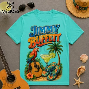 Jimmy Buffett I May Be Old Turquoise T-Shirt featuring a tropical parrot, acoustic guitar, margarita, and palm tree art.