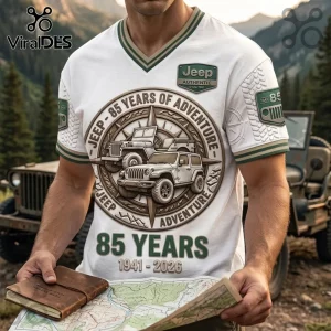 White V-neck t-shirt featuring Jeep 85 Years of Adventure graphic, compass design, and 1941-2026 text against mountains.!
