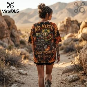 Woman wearing an orange and black tie-dye t-shirt featuring a cartoon rat driving a hot rod with No Mercy Just Power text.!