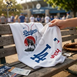 Godzilla Minus One x Los Angeles Dodgers 2026 Baseball Jersey featuring white fabric, blue lettering, and monster graphics.