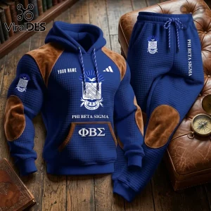 Blue quilted Phi Beta Sigma hoodie and jogger set with brown suede elbow and knee patches on a leather chair background.!