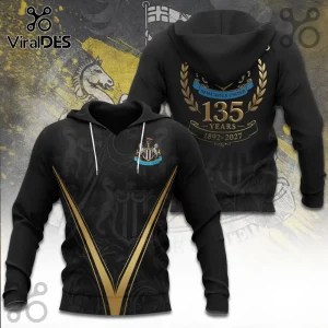 Newcastle United black hoodie with gold 135 years anniversary text, club crest, and horse graphics on a patterned background.!
