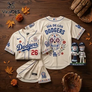 Los Angeles Dodgers Dia De Los Muertos cream baseball jersey with sugar skull graphics on a rustic wooden background.