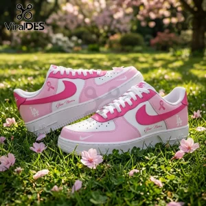 Custom Los Angeles Dodgers sneakers in pink and white with breast cancer awareness ribbons sitting on green grass.!