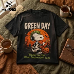 Green Day x Snoopy Halloween black T-shirt featuring a punk Snoopy playing a guitar with a skeleton outfit and mohawk.