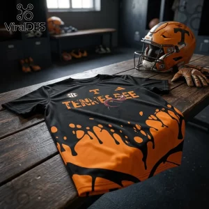 Black and orange Tennessee Volunteers athletic t-shirt with drip paint design and SEC logo on a wooden locker room bench.!