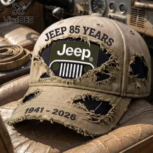 Distressed beige baseball cap with Jeep 85 Years 1941-2026 text and Jeep grille logo patch on vintage vehicle interior.!