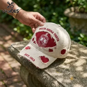 Beige distressed baseball cap featuring crimson Delta Sigma Theta embroidery and crest on a stone background.!