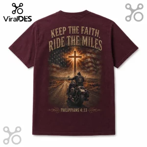 Maroon t-shirt featuring a motorcyclist, American flag, glowing cross, and text Keep the Faith Ride the Miles.!