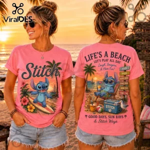 Pink crew neck t-shirt featuring Disney Stitch surfing on front and relaxing on beach graphic on back with tropical text.!