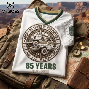 White V-neck shirt featuring a circular Jeep 85 Years of Adventure graphic, compass design, and 1941-2026 text.!