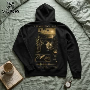 Black hoodie featuring French Kiwi Juice text, a tropical landscape, and a musician playing piano keys in gold tones.!