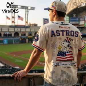 Man wearing Houston Astros baseball jersey with Snoopy, American flag, and 250 years of freedom 1776-2026 text graphics.!