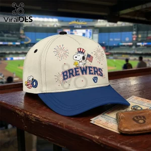 Cream and blue baseball cap featuring Snoopy, Woodstock, fireworks, American flag, and Milwaukee Brewers branding.!