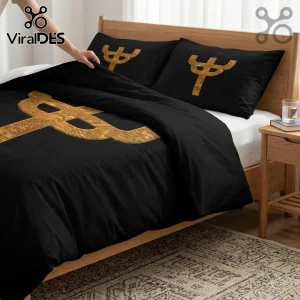Black bedding set featuring a large gold trident-shaped symbol with ornate interior patterns on duvet and pillowcases.!