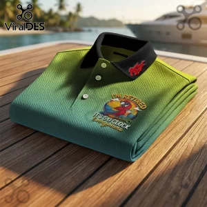 Jimmy Buffett Personalized Parrot Polo Shirt in green gradient fabric with a tropical bird logo on a wooden boat deck.