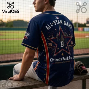 Man wearing a navy blue 2026 MLB All-Star Game jersey featuring a star graphic, Philadelphia skyline, and text on back.!
