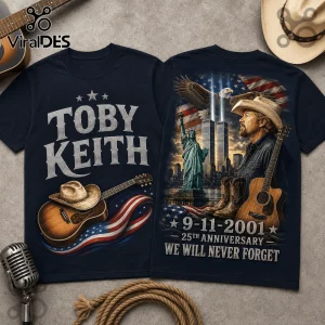 Toby Keith 9/11 25th Anniversary T-Shirt showing a navy blue design with a guitar, eagle, Statue of Liberty, and flag.