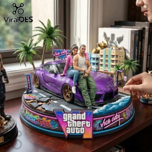 Grand Theft Auto VI diorama featuring a purple sports car, two figures, palm trees, and art deco hotel on a round base.!