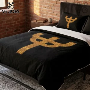 Black bedding set with gold trident emblem on duvet and pillowcase, centered in bedroom with exposed brick wall.!