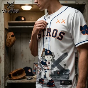 Houston Astros baseball jersey with KAWS companion character graphic, white fabric, blue piping, and orange XX logos.!