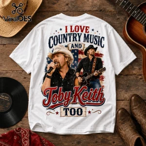 White t-shirt featuring Toby Keith singing and playing guitar over a US flag design with text I Love Country Music Too.!