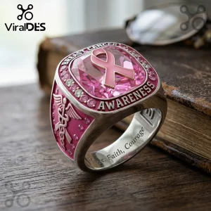 Silver breast cancer awareness ring with a pink center stone, pink ribbon emblem, caduceus symbol, and engraved band.!
