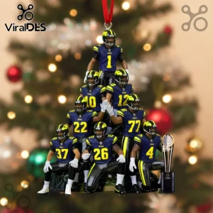 Michigan football player figurines in a pyramid formation wearing blue and yellow uniforms with a miniature trophy.!