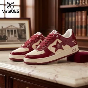 Maroon and cream patent leather sneakers featuring Greek letters delta, sigma, theta and a star emblem on a marble desk.!