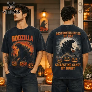 Godzilla Destroying Cities Halloween T-Shirt featuring a black graphic of Godzilla with orange pumpkins on dark fabric.